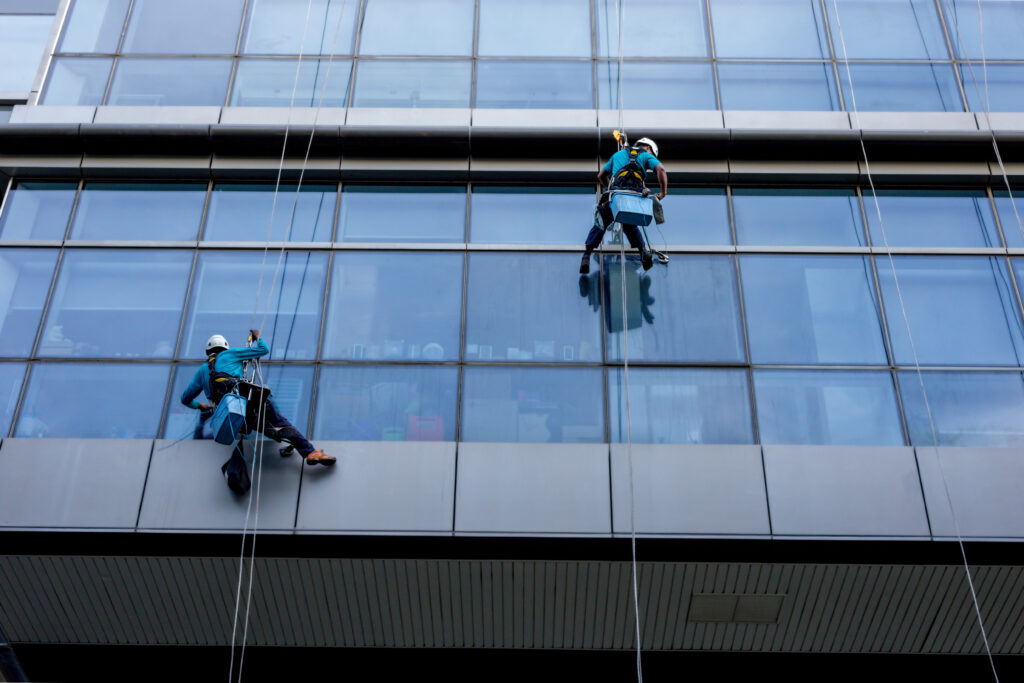 window cleaner working glass scaled